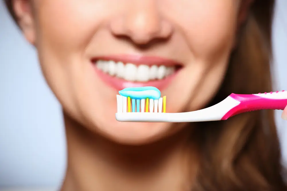 Toothbrush with fluoride toothpaste