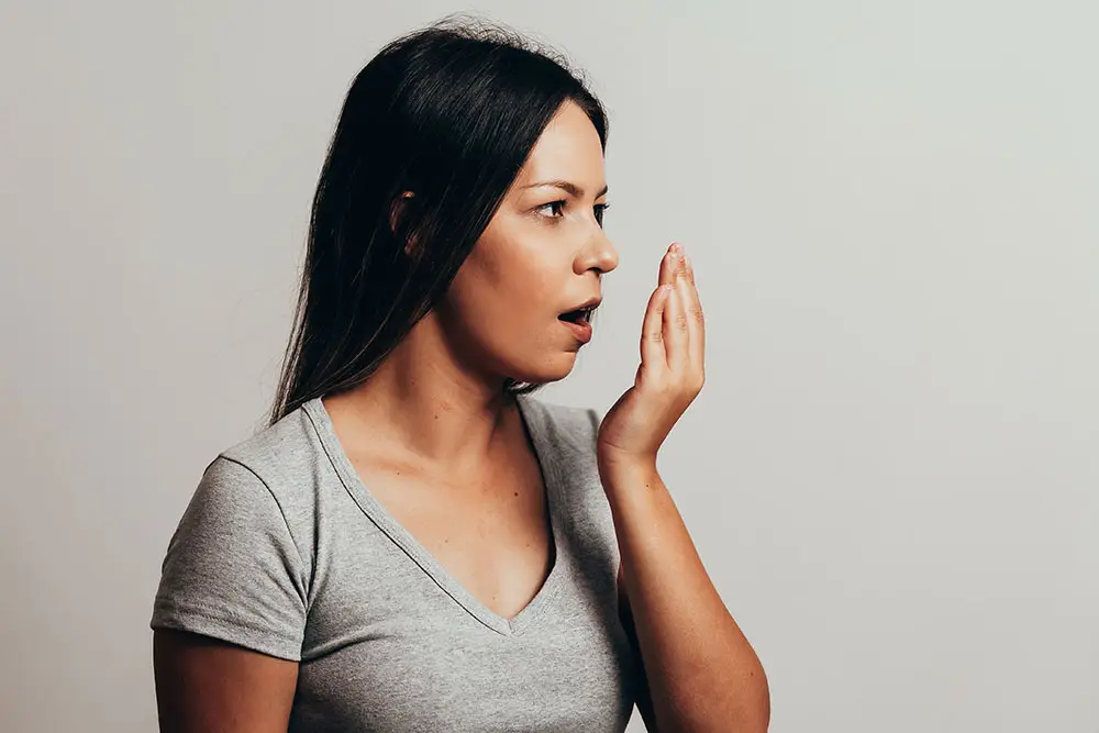 Woman cupping her mouth
